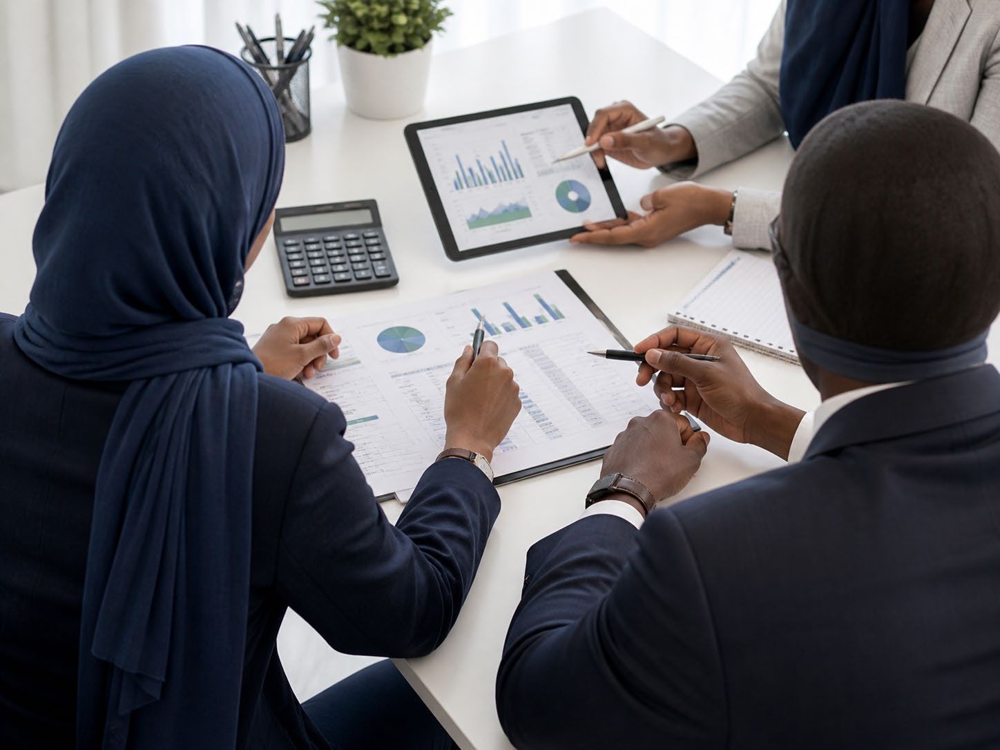 Somali professionals collaborating around financial reports